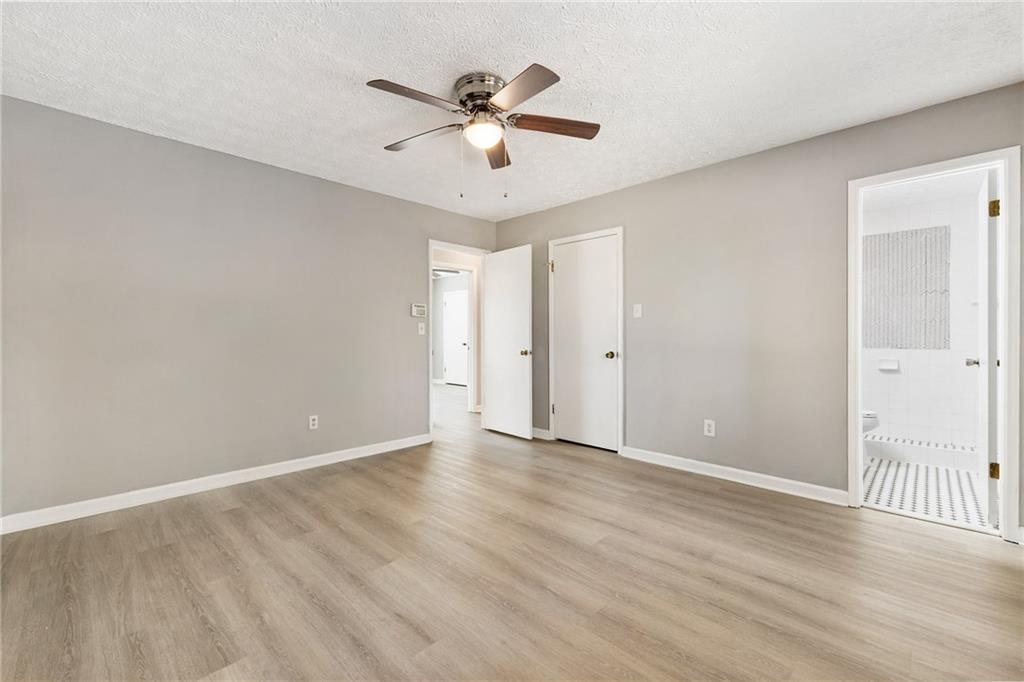130 Forrest View Terrace Johns Creek, GA 30022 - Photo 20 of 34 an empty room with wooden floor fan and windows
