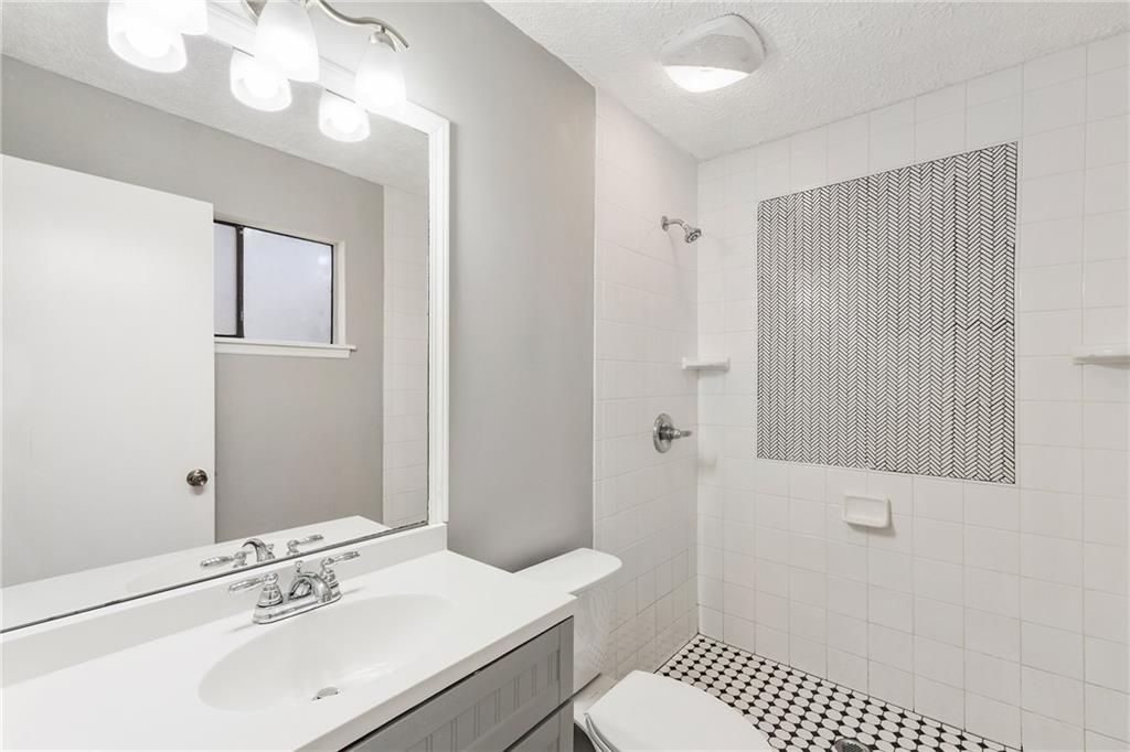 130 Forrest View Terrace Johns Creek, GA 30022 - Photo 21 of 34 a bathroom with a sink a toilet and shower