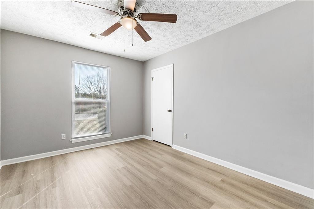 130 Forrest View Terrace Johns Creek, GA 30022 - Photo 26 of 34 an empty room with a window and a ceiling fan