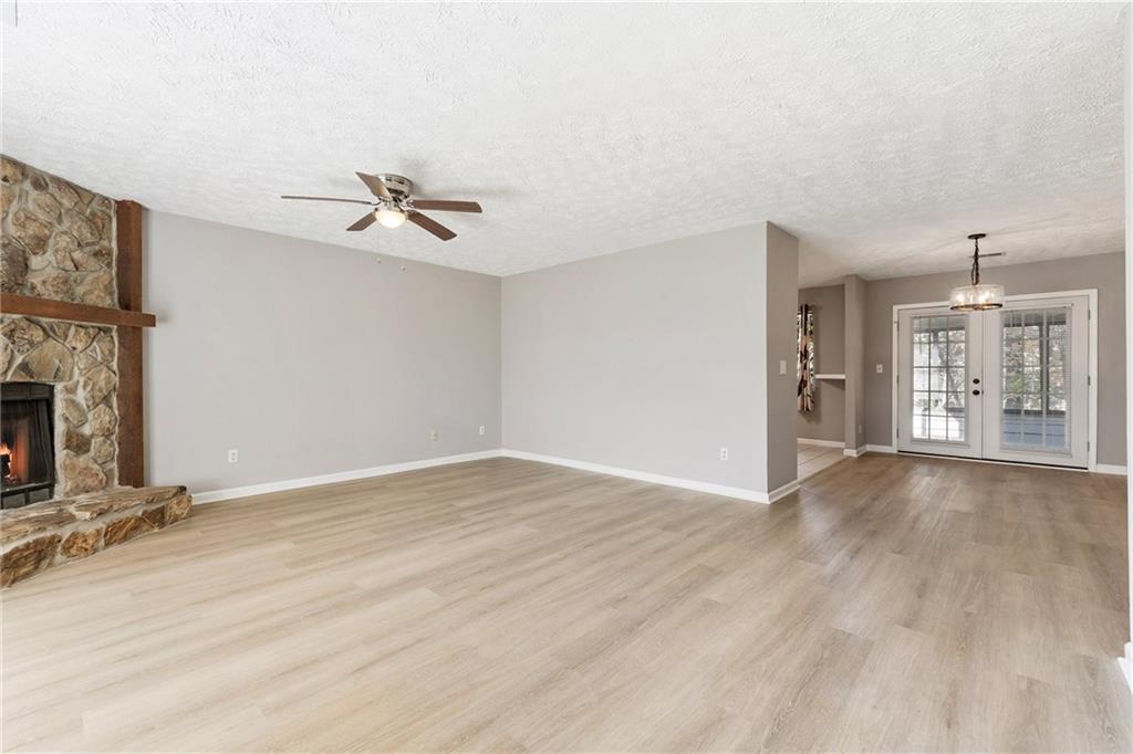 130 Forrest View Terrace Johns Creek, GA 30022 - Photo 4 of 34 wooden floor in an empty room with a fireplace
