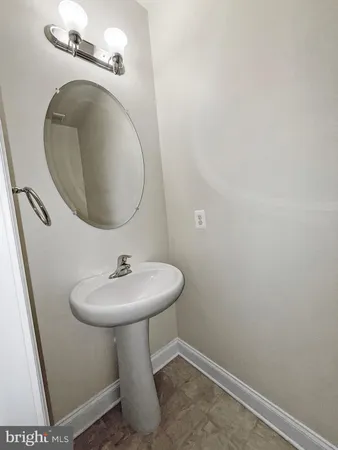 a bathroom with a sink toilet and mirror