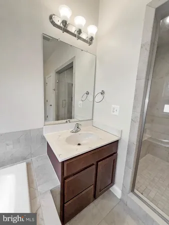 a bathroom with a sink a mirror and vanity