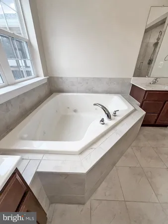 a bath tub sitting in a bathroom next to a window