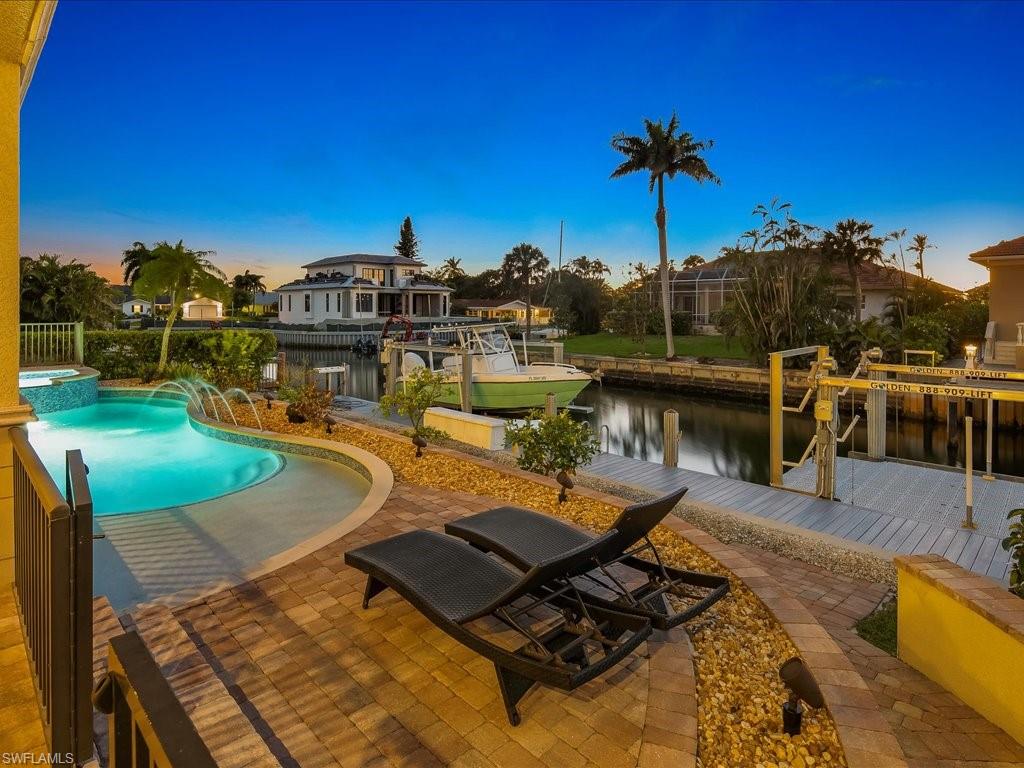 1550 Mullet Lane Naples, FL 34102 - Photo 11 of 50 a view of a swimming pool with a chairs