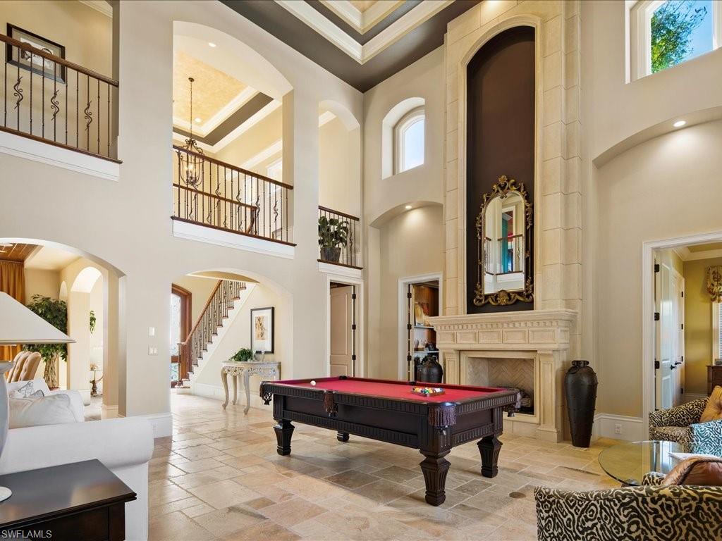 1550 Mullet Lane Naples, FL 34102 - Photo 16 of 50 a living room with fireplace furniture and a rug