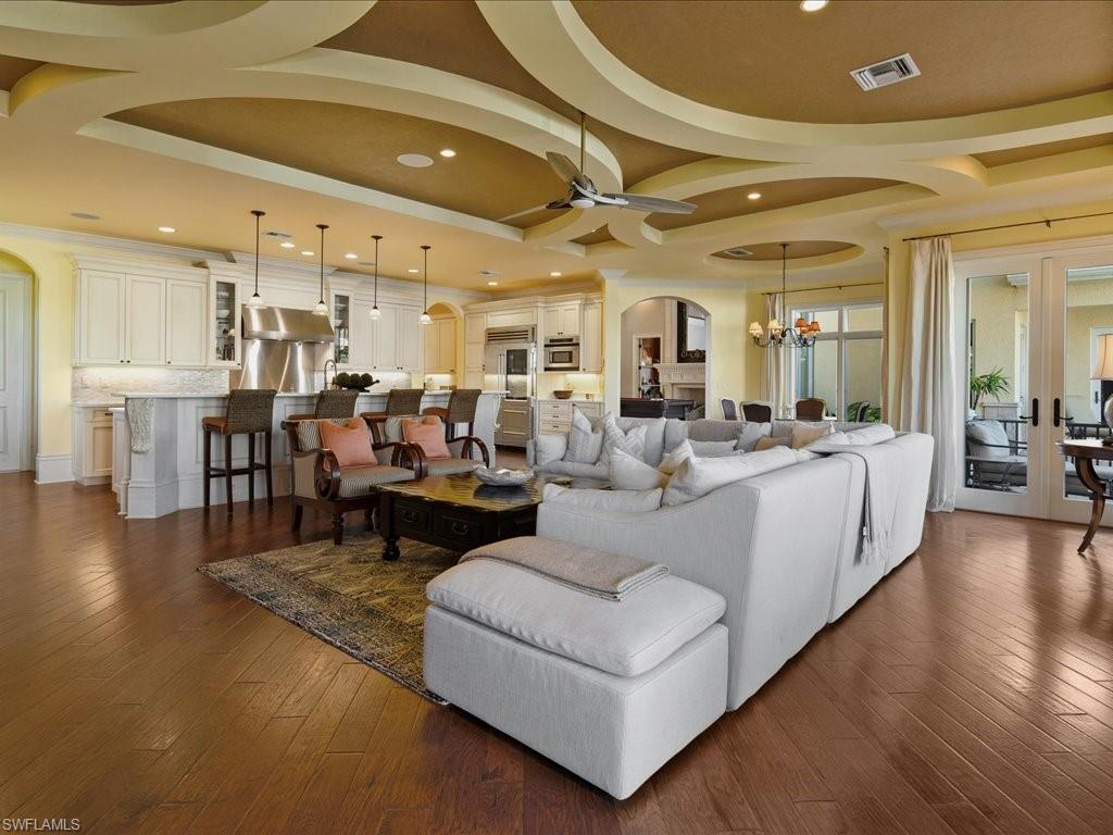 1550 Mullet Lane Naples, FL 34102 - Photo 27 of 50 a living room with lots of furniture and kitchen view