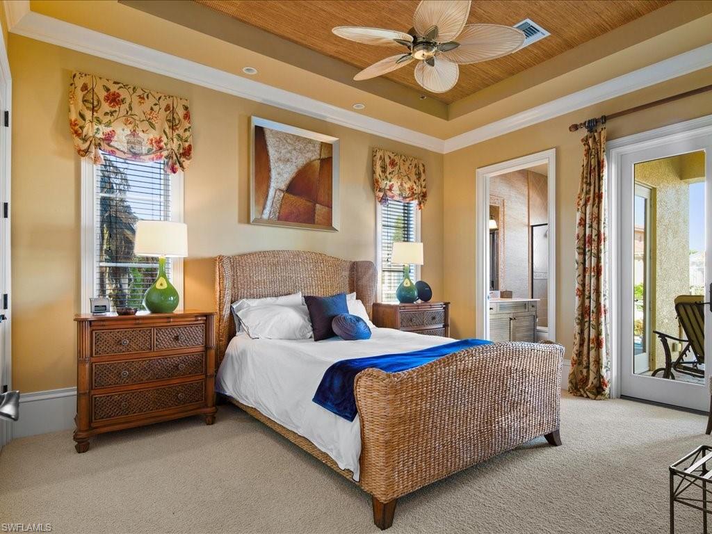 1550 Mullet Lane Naples, FL 34102 - Photo 29 of 50 a bedroom with a bed and a chandelier