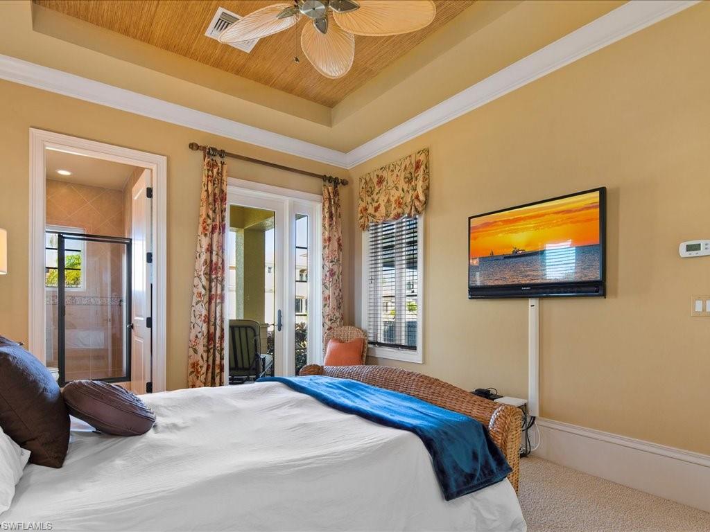 1550 Mullet Lane Naples, FL 34102 - Photo 30 of 50 a bedroom with a bed and a flat screen tv