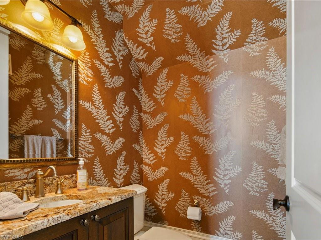 1550 Mullet Lane Naples, FL 34102 - Photo 33 of 50 a bathroom with a granite countertop sink and a mirror