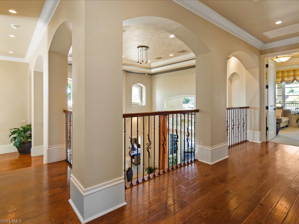 1550 Mullet Lane Naples, FL 34102 - Photo 34 of 50 wooden floor in a hall with a window and a living room