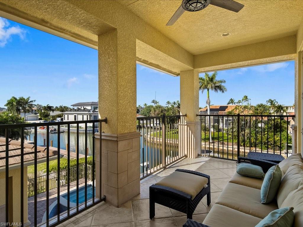 1550 Mullet Lane Naples, FL 34102 - Photo 38 of 50 a balcony with furniture and city view