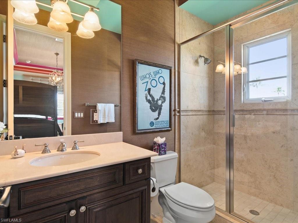 1550 Mullet Lane Naples, FL 34102 - Photo 44 of 50 a bathroom with a sink a toilet a mirror and shower