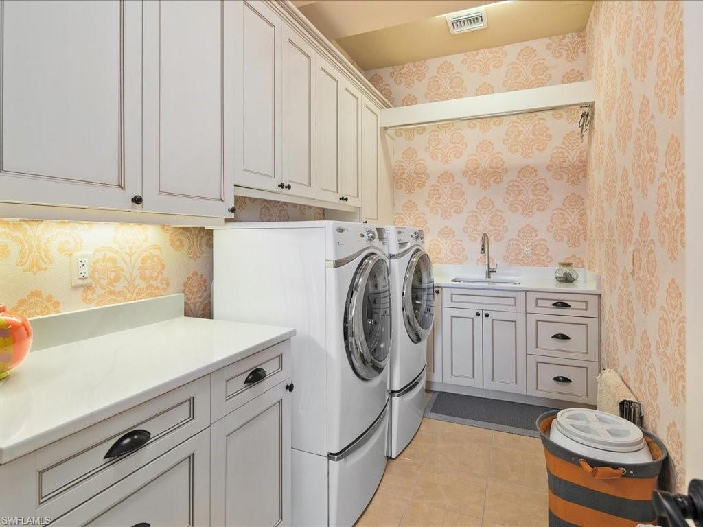 1550 Mullet Lane Naples, FL 34102 - Photo 47 of 50 a utility room with stainless steel appliances a stove a sink and cabinets