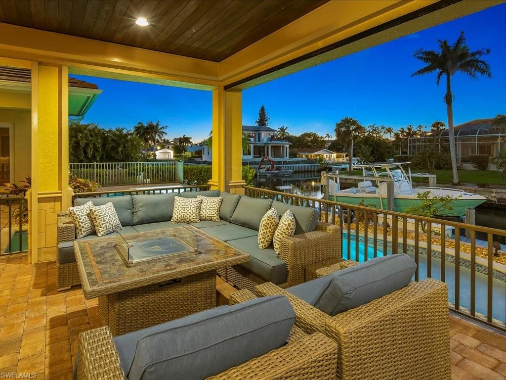 1550 Mullet Lane Naples, FL 34102 - Photo 6 of 50 a roof deck with couches and wooden floor