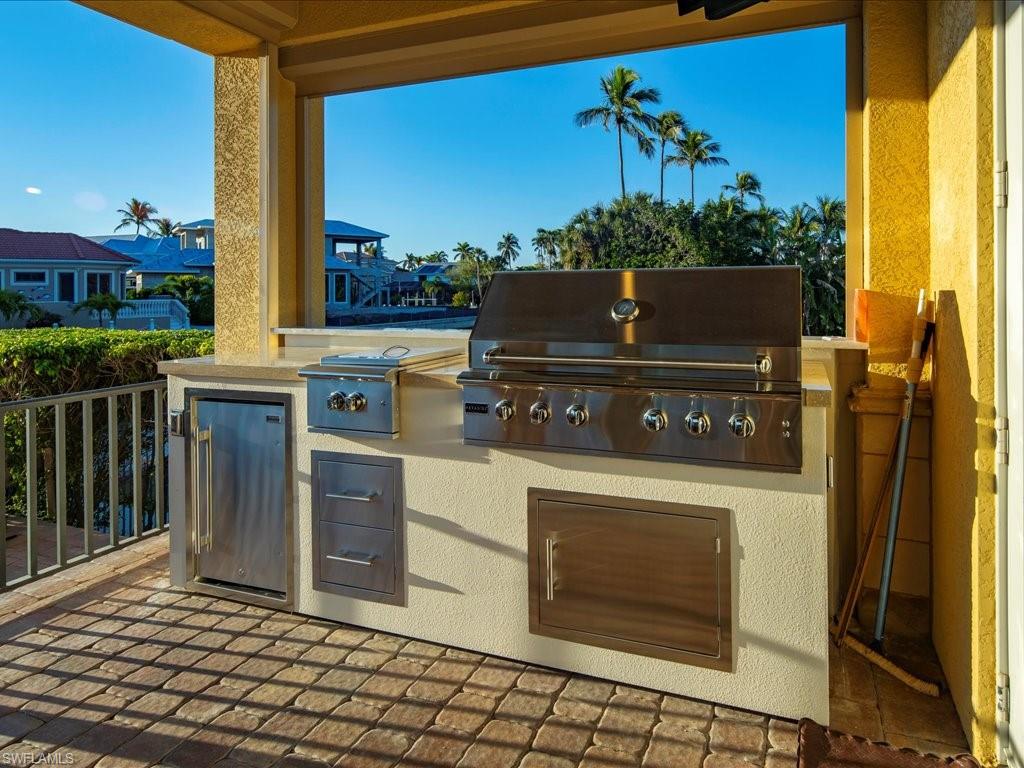 1550 Mullet Lane Naples, FL 34102 - Photo 7 of 50 a stove top oven sitting inside of a kitchen
