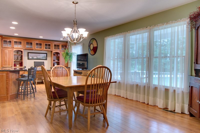 4675 Richman Road Litchfield, OH 44253 - Photo 7 of 30 The formal dining area has large windows overlooking the front porch and front yard and is open to the kitchen. new laminate flooring runs throughout both the kitchen and dining room.