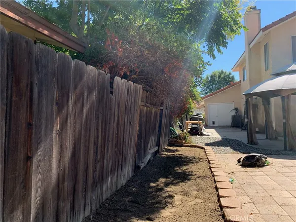 a view of a backyard with wooden fence