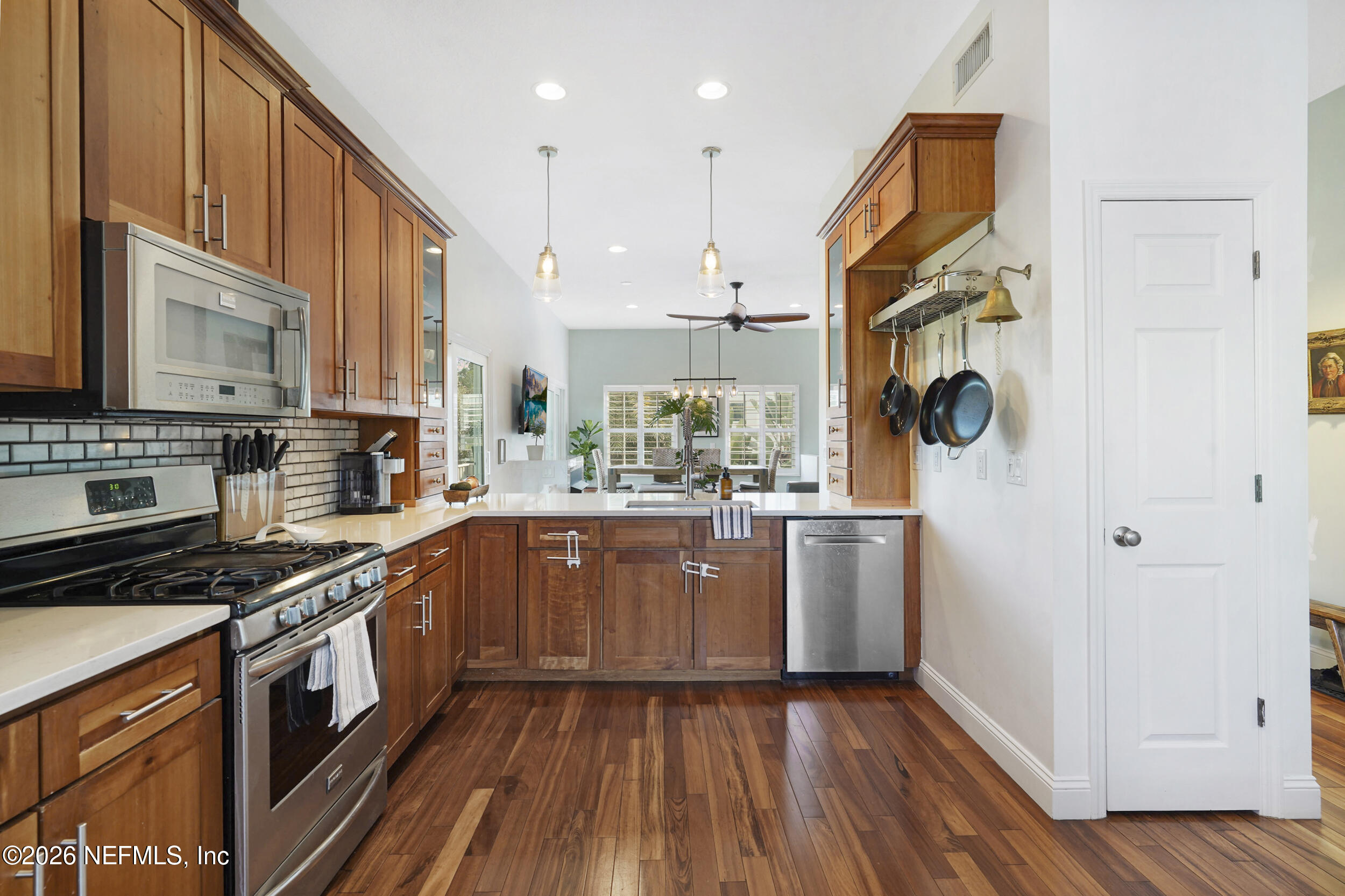 3336 Carmel Road St. Augustine, FL 32086 - Photo 13 of 55 a kitchen with stainless steel appliances granite countertop a stove a sink dishwasher and a refrigerator