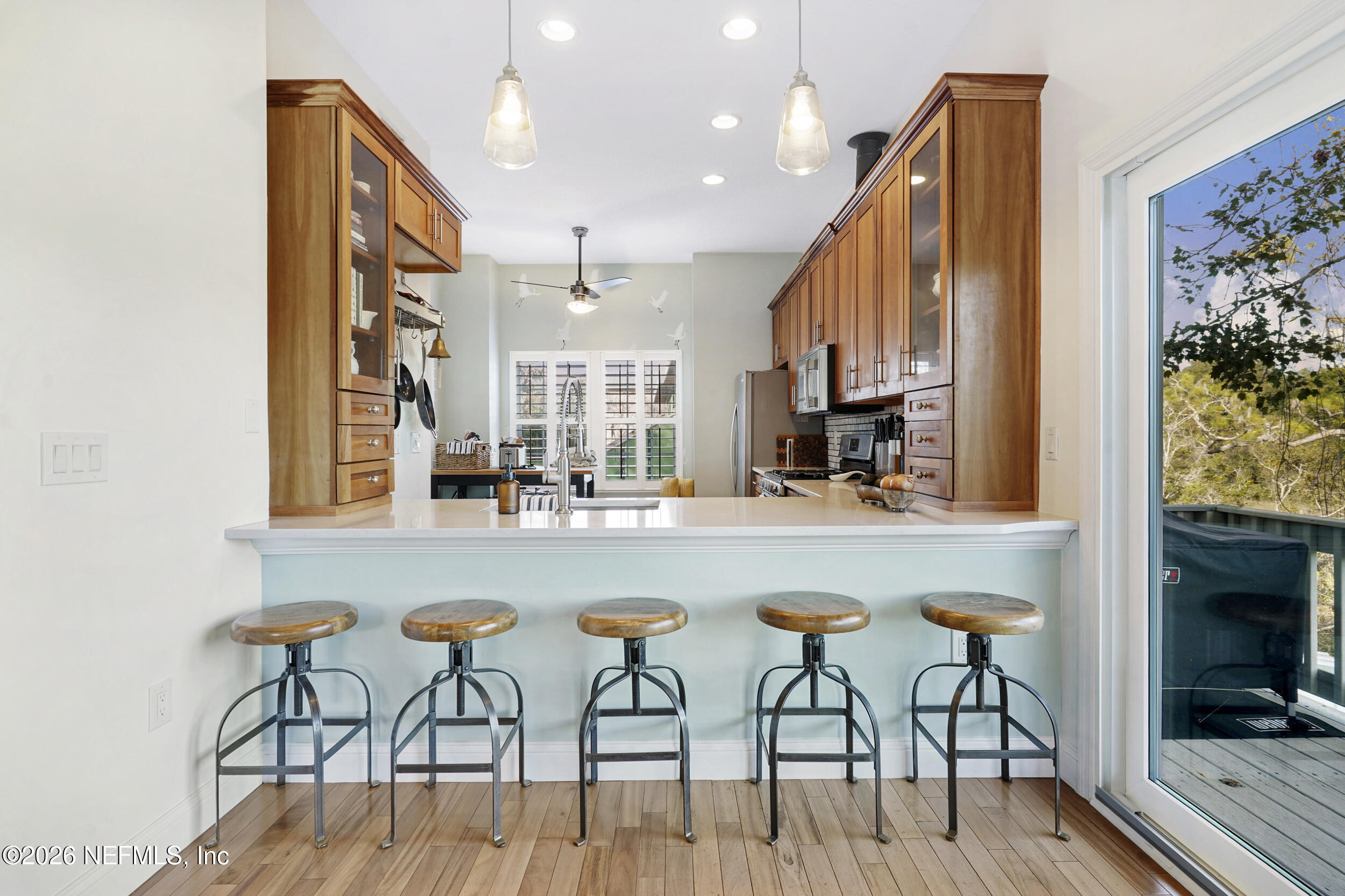 3336 Carmel Road St. Augustine, FL 32086 - Photo 19 of 55 a kitchen with stainless steel appliances granite countertop a table chairs and a refrigerator