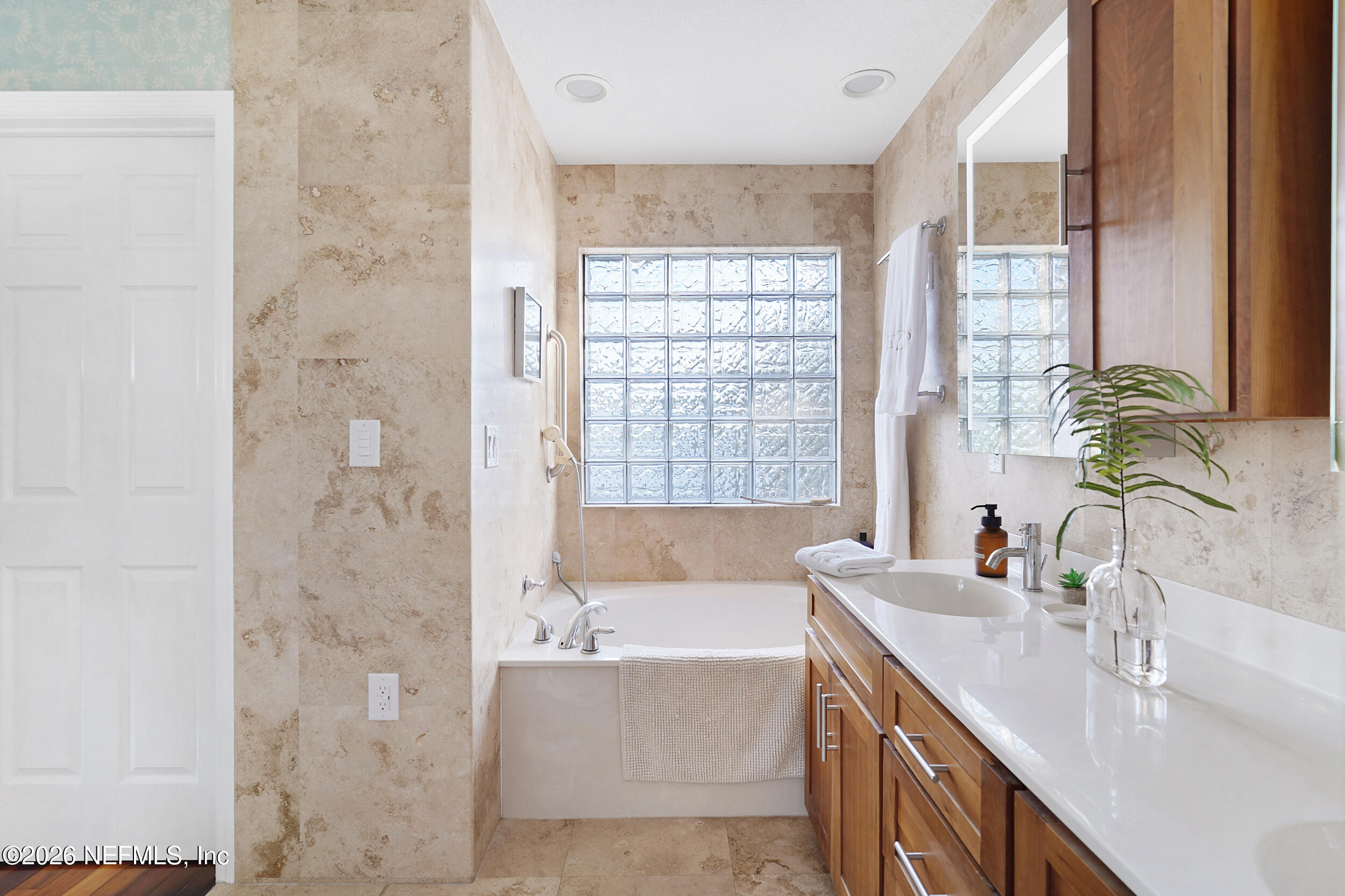 3336 Carmel Road St. Augustine, FL 32086 - Photo 32 of 55 a bathroom with a granite countertop sink a bathtub and next to a window