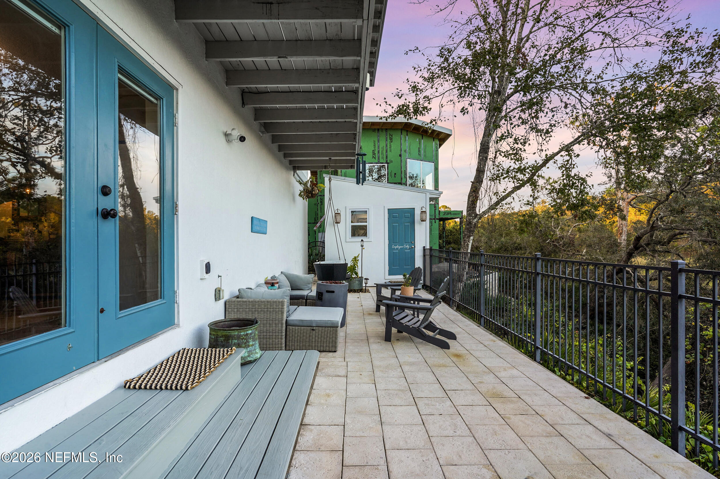 3336 Carmel Road St. Augustine, FL 32086 - Photo 39 of 55 a view of a patio with couches table and chairs and potted plants