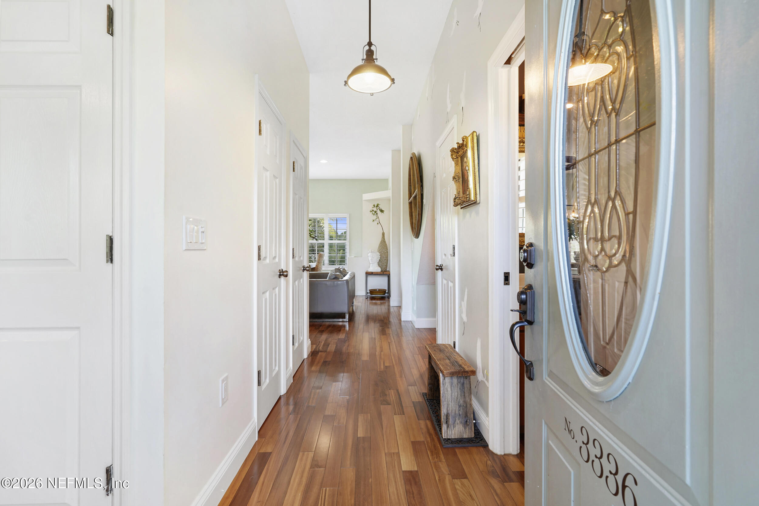 3336 Carmel Road St. Augustine, FL 32086 - Photo 6 of 55 a view of a hallway with wooden floor and a bathroom