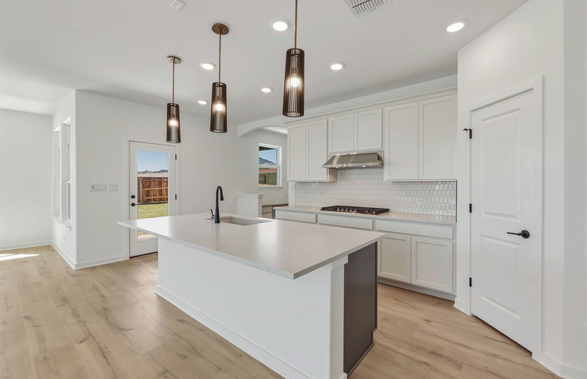 536 Rubber Tree Way Buda, TX 78610 - Photo 5 of 32 a kitchen with stainless steel appliances granite countertop a sink a stove and a refrigerator