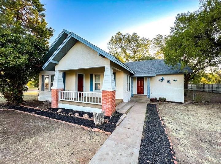 1201 Union Avenue Rule, TX 79547 - Photo 1 of 1 a front view of a house with a yard outdoor seating and yard in the back
