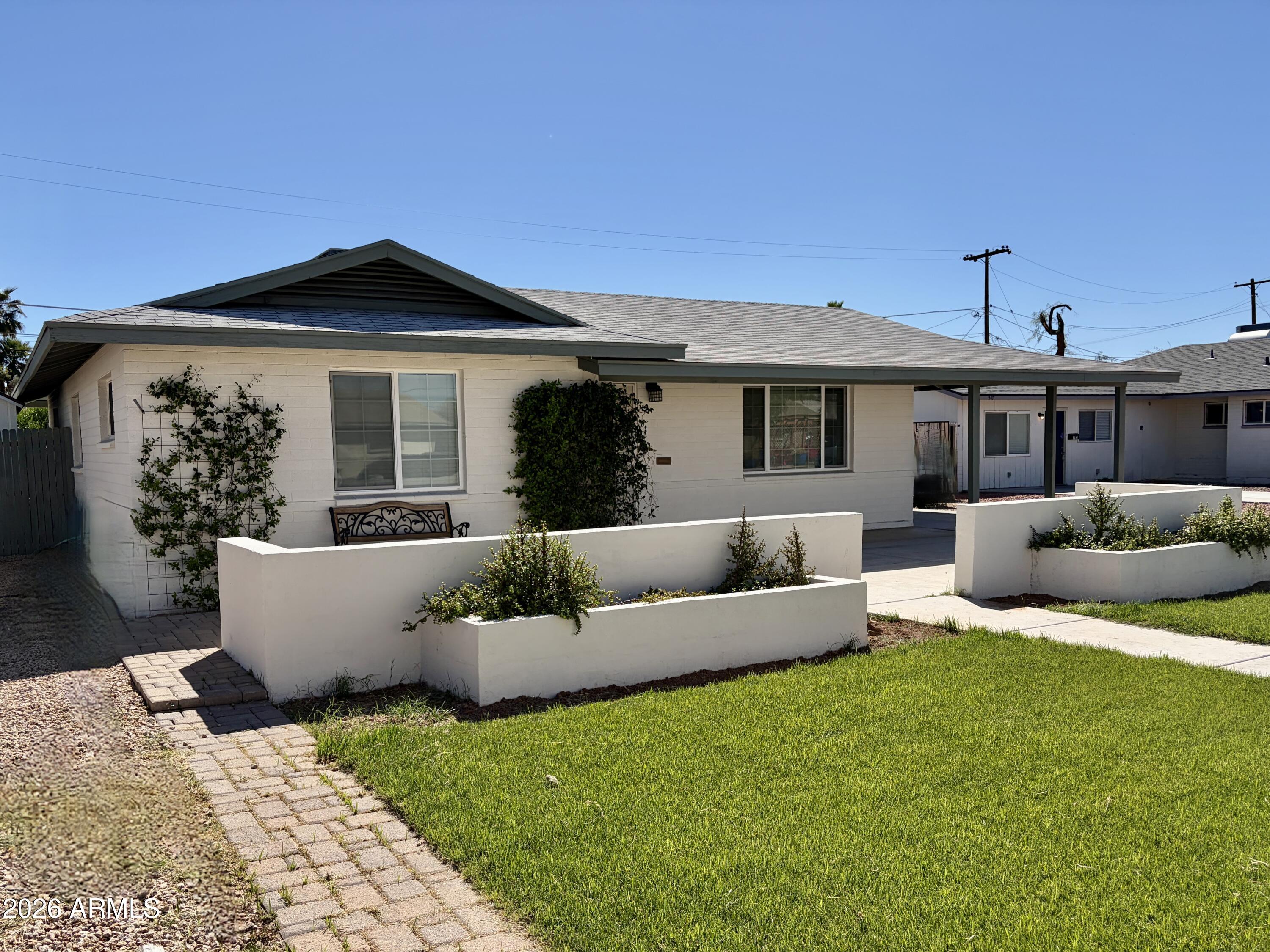 a view of a house with couches and wooden floor