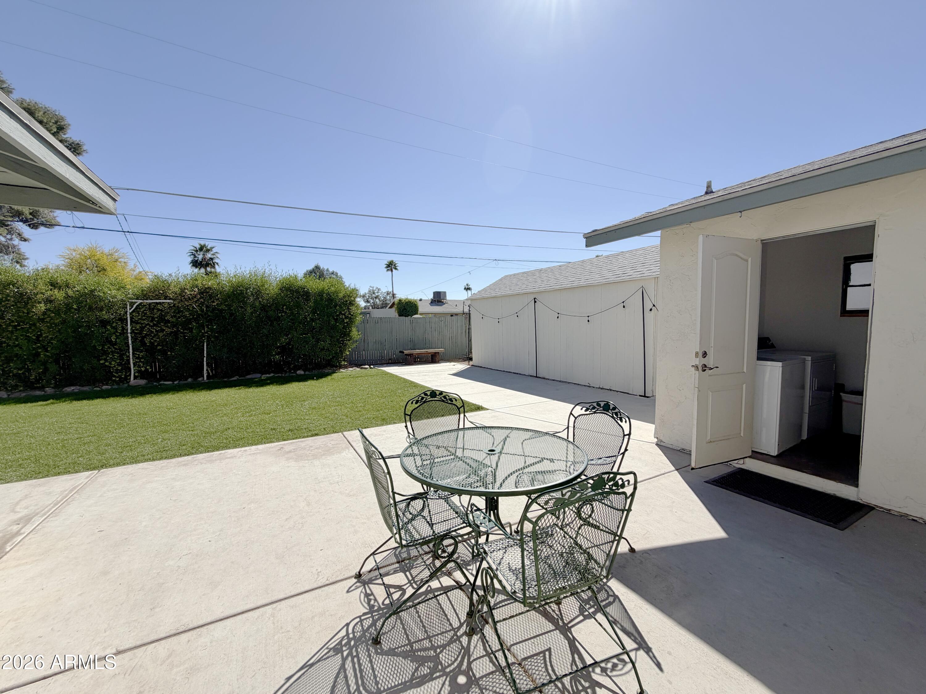 543 West 18th Street Tempe, AZ 85281 - Photo 21 of 29 a view of a backyard with table and chairs with wooden fence