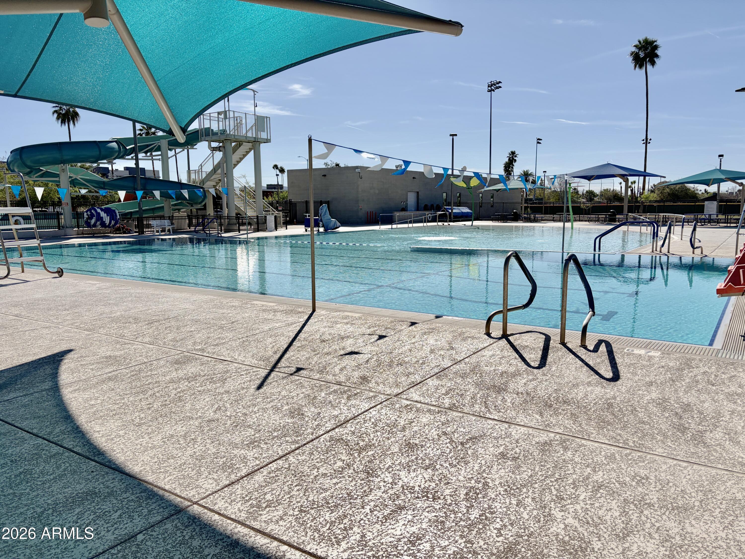 543 West 18th Street Tempe, AZ 85281 - Photo 27 of 29 a view of a swimming pool with a bench and chairs