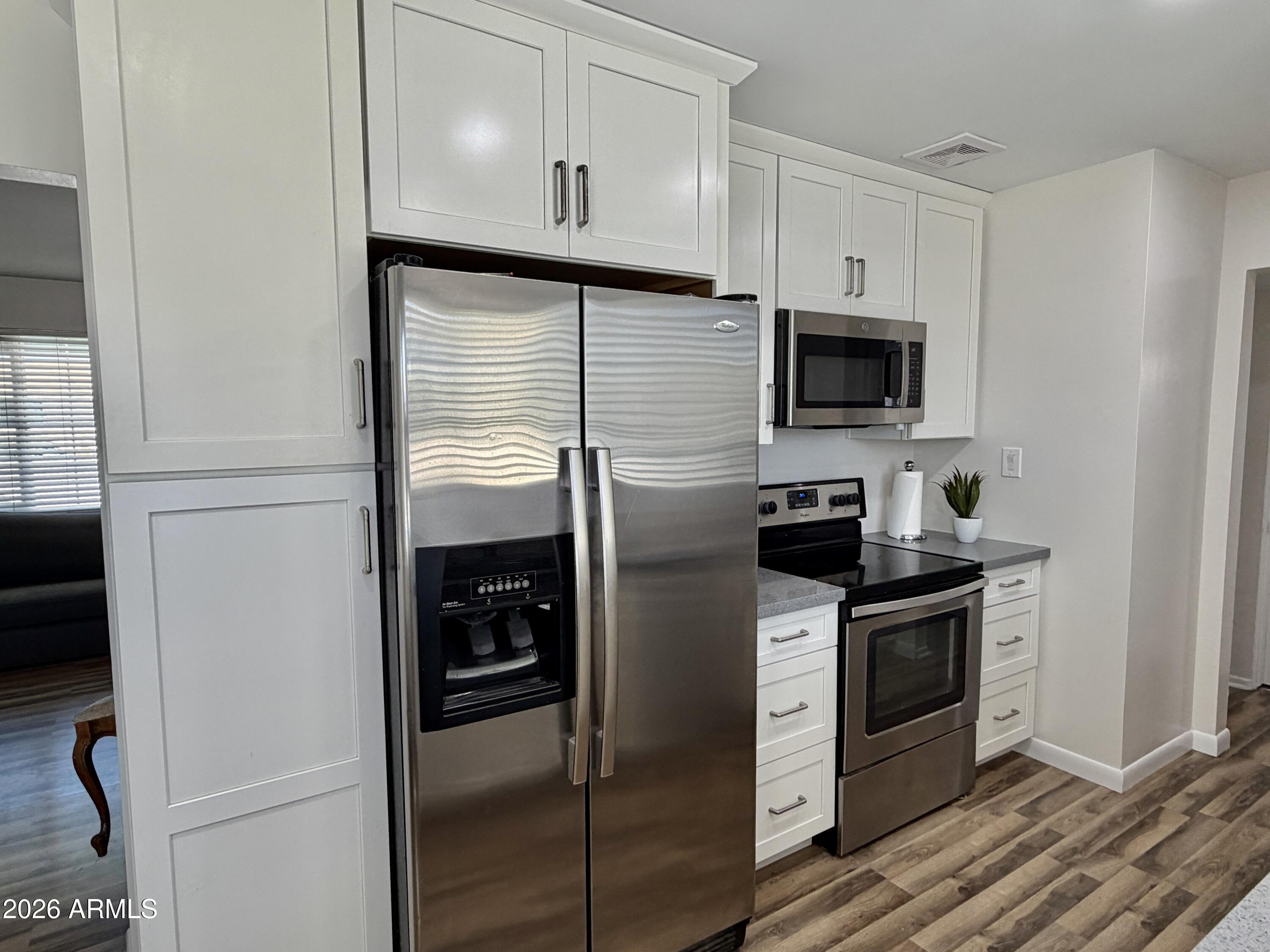 543 West 18th Street Tempe, AZ 85281 - Photo 6 of 29 a kitchen with a refrigerator stove and microwave