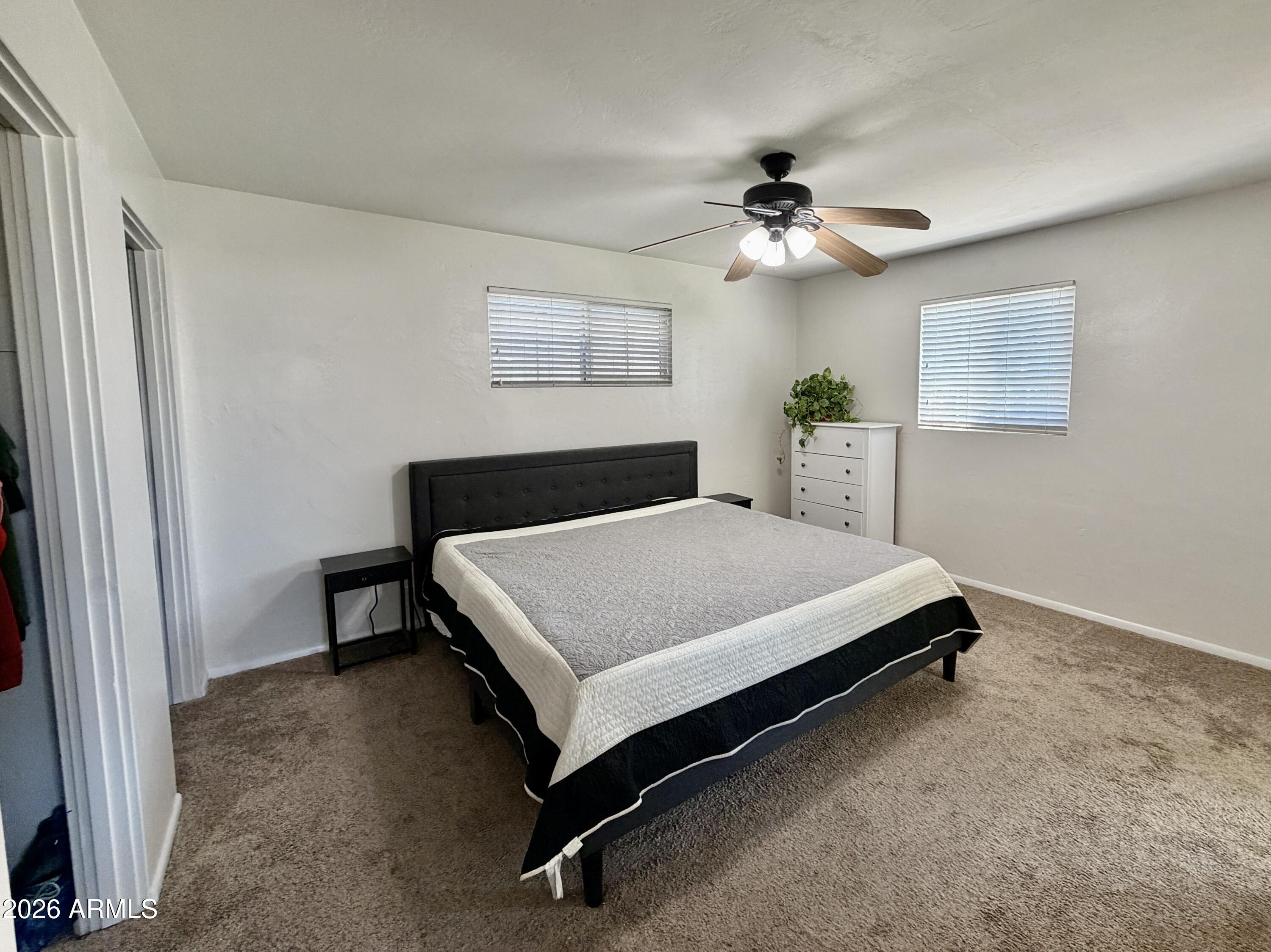 543 West 18th Street Tempe, AZ 85281 - Photo 9 of 29 a bedroom with a bed and a ceiling fan
