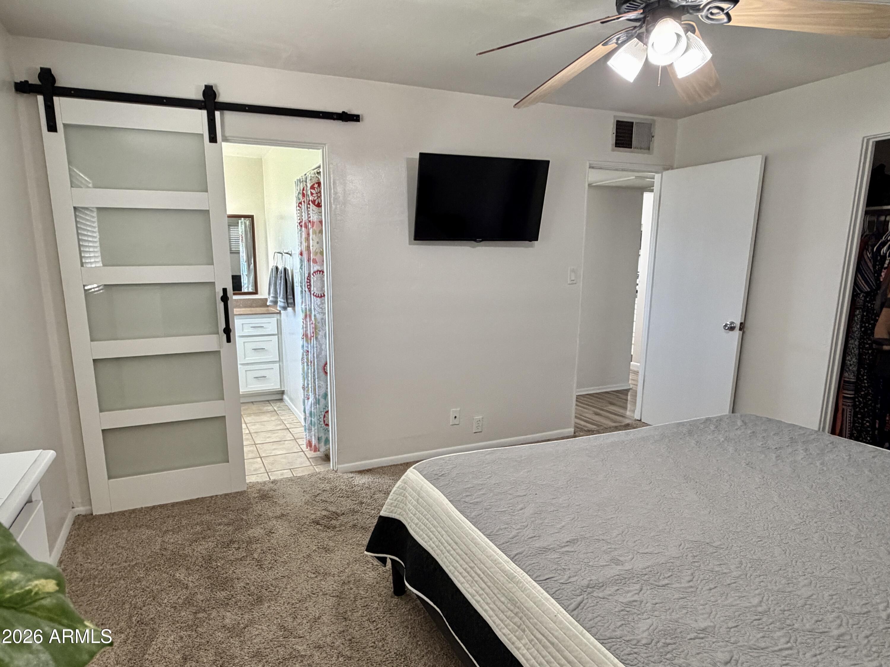 543 West 18th Street Tempe, AZ 85281 - Photo 10 of 29 a spacious bedroom with a bed and a flat screen tv