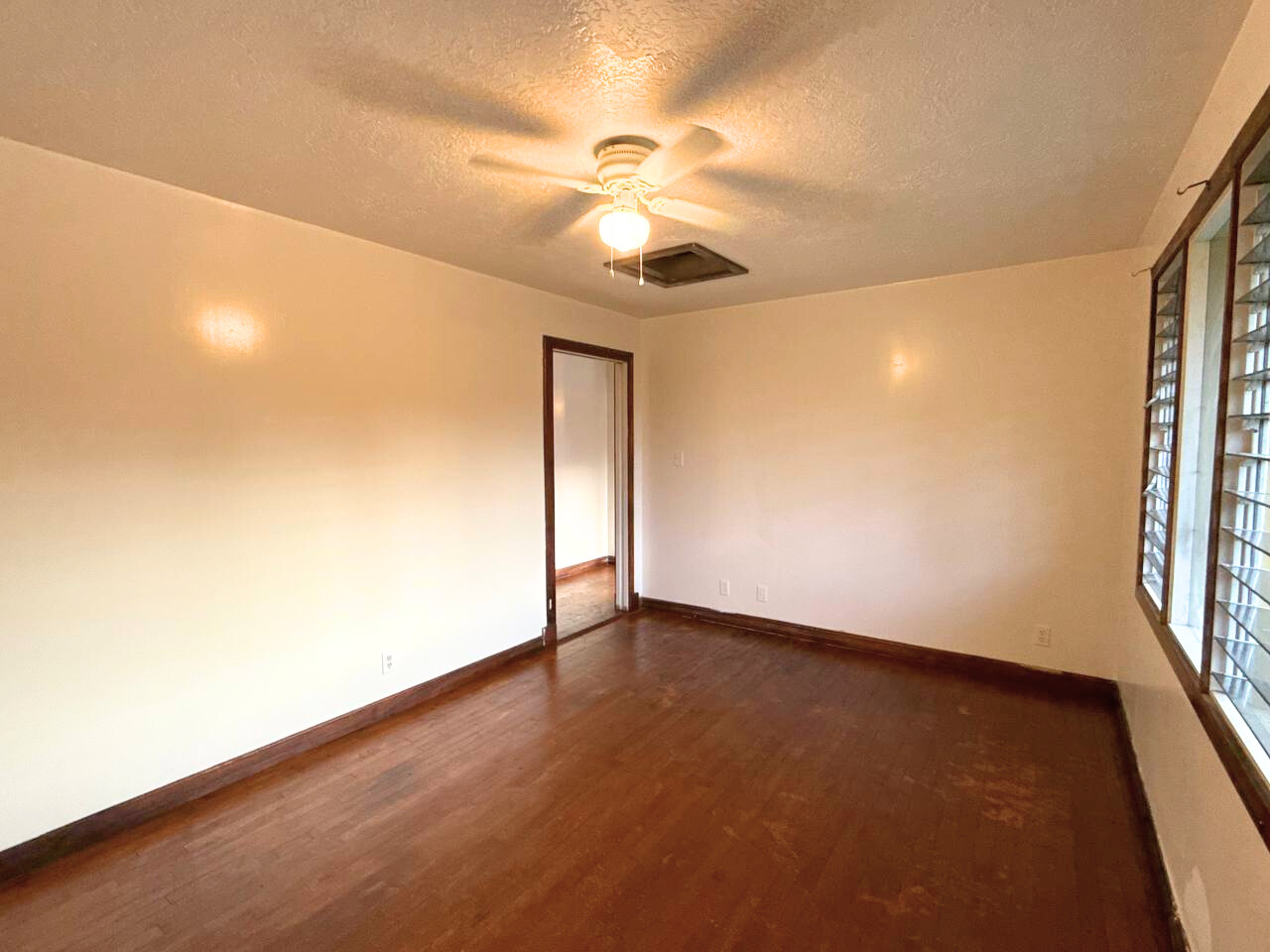 15-1485 Post Road Pahoa, HI 96778 - Photo 13 of 18 an empty room with wooden floor fan and windows