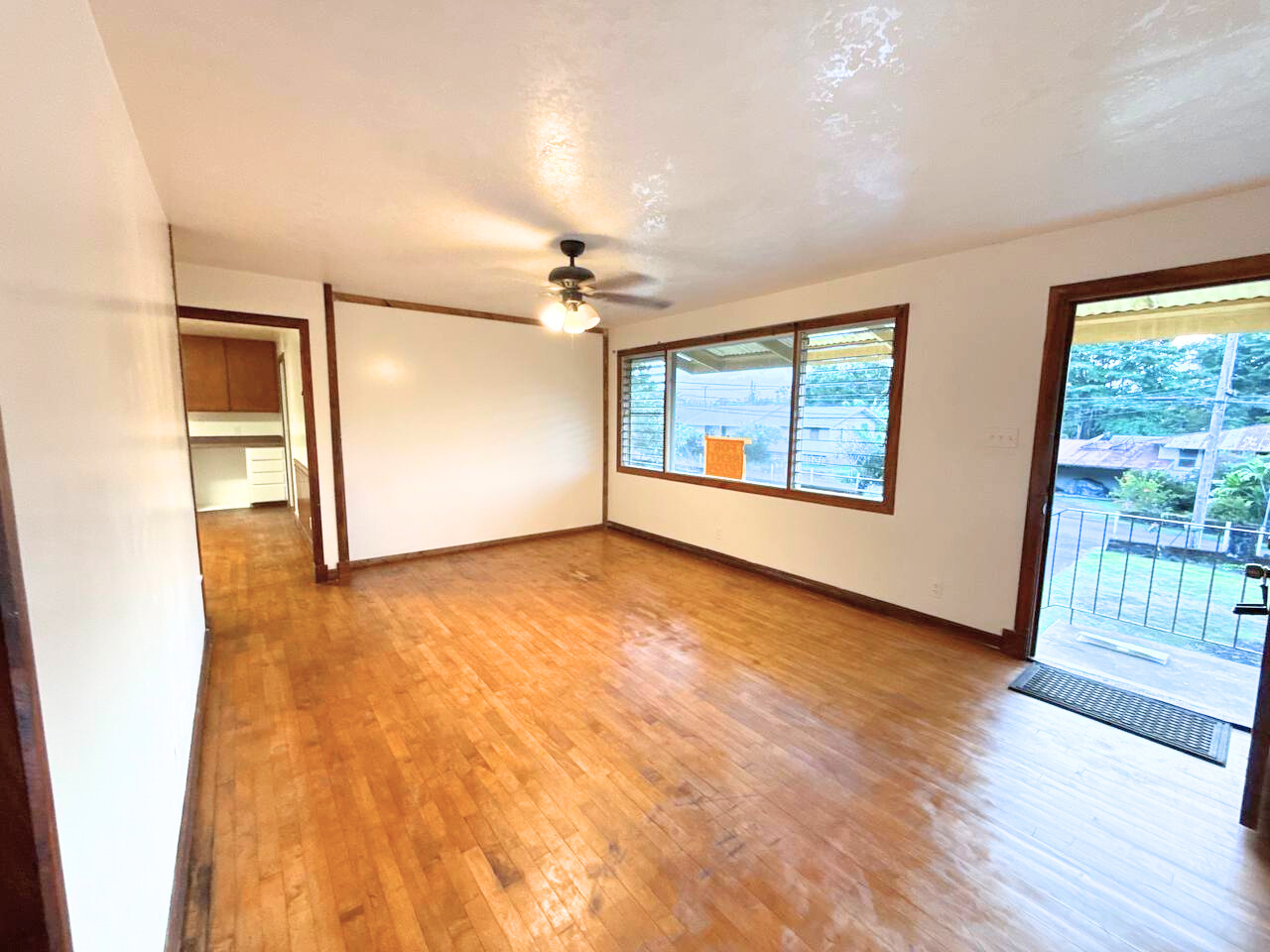 15-1485 Post Road Pahoa, HI 96778 - Photo 3 of 18 an empty room with wooden floor and windows
