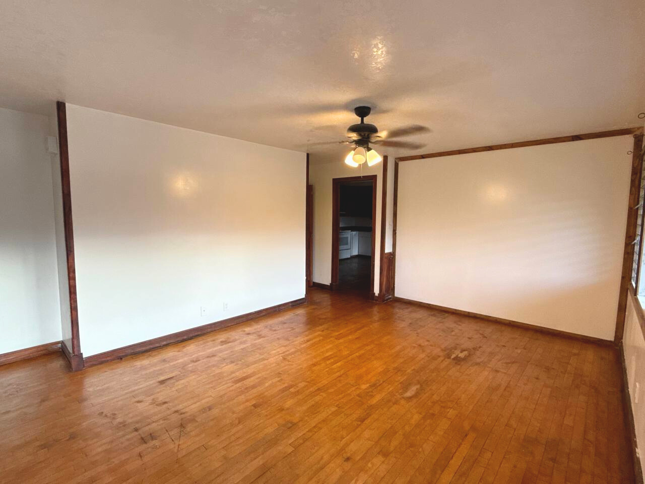 15-1485 Post Road Pahoa, HI 96778 - Photo 6 of 18 an empty room with wooden floor and chandelier fan