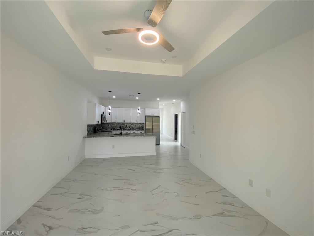 5444 Billings Street Lehigh Acres, FL 33971 - Photo 23 of 32 a view of a kitchen with a sink and cabinets