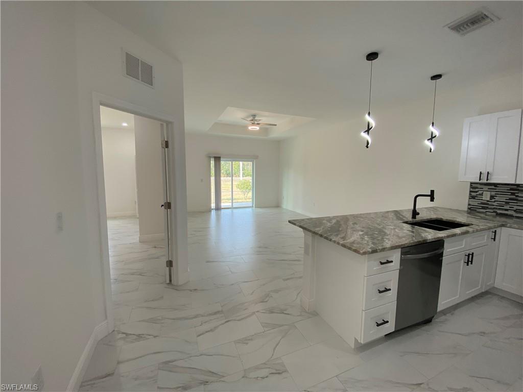 5444 Billings Street Lehigh Acres, FL 33971 - Photo 24 of 32 a kitchen with granite countertop a sink and a stove