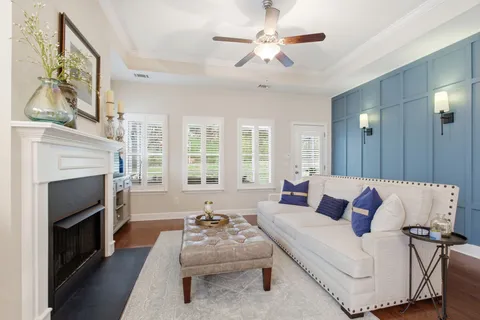 a living room with furniture fireplace and flat screen tv