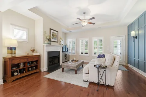 a living room with furniture a fireplace and a window