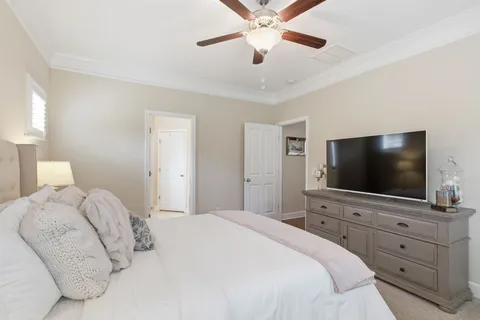 a bedroom with a large bed and a flat screen tv