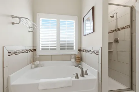 a white bath tub sitting next to a window