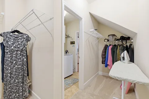 a view of walk in closet with clothes and shoes