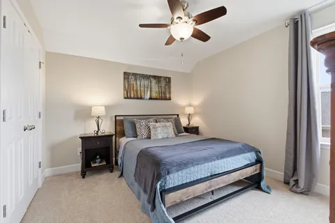 a bedroom with a bed and a chandelier