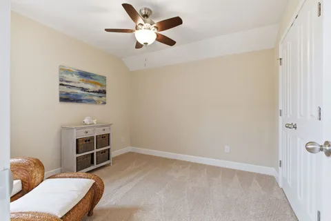 a view of workspace with furniture and ceiling fan