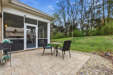 a view of a chair and table on the patio