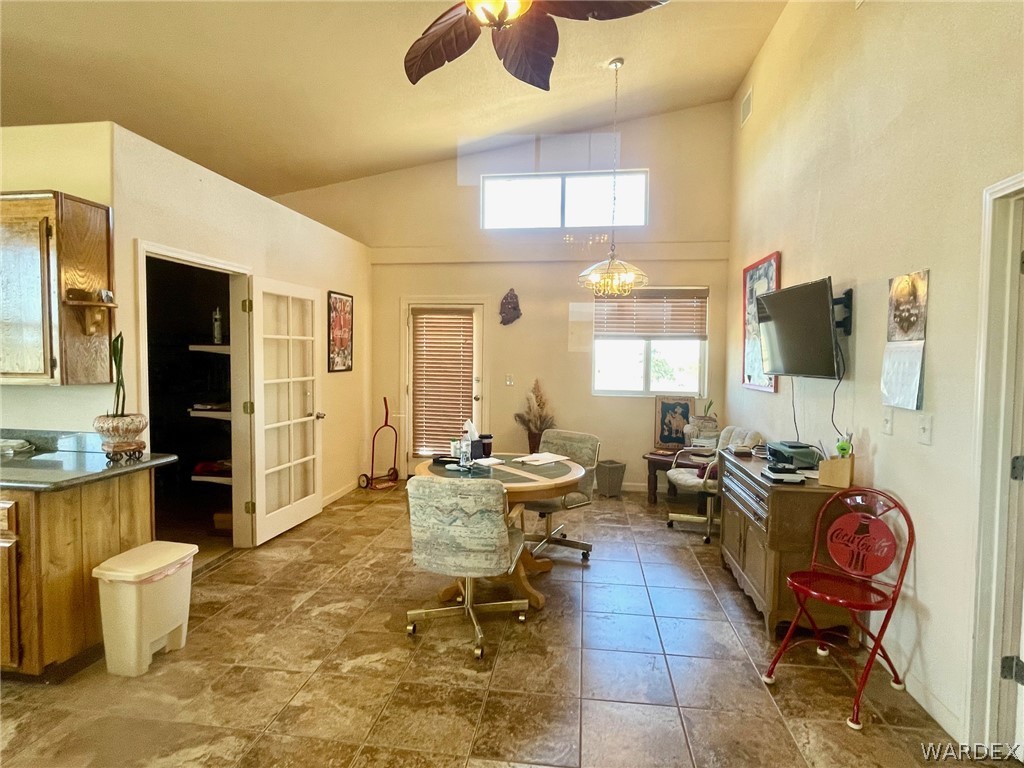 21477 South Sundance Kid Road Yucca, AZ 86438 - Photo 17 of 66 a living room with furniture a flat screen tv and large window