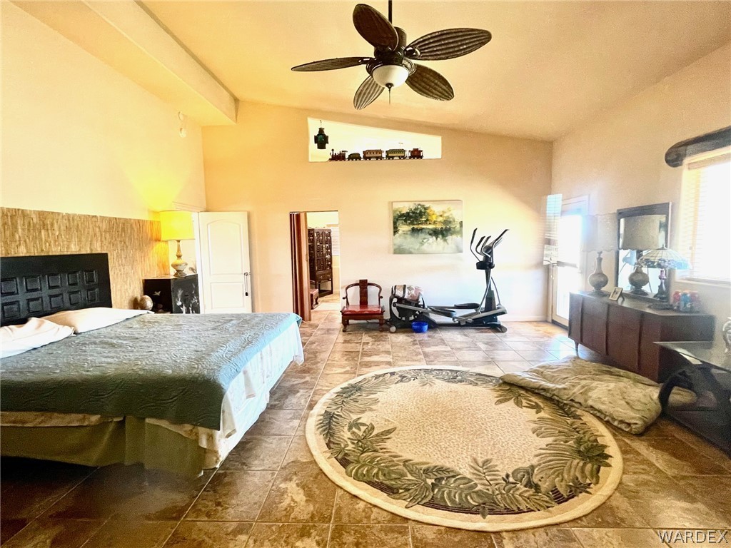 21477 South Sundance Kid Road Yucca, AZ 86438 - Photo 21 of 66 a bed room with a bed and a chandelier