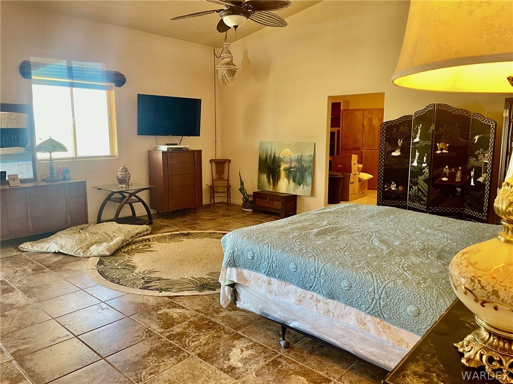 21477 South Sundance Kid Road Yucca, AZ 86438 - Photo 23 of 66 a bed sitting in a bedroom and a flat screen tv